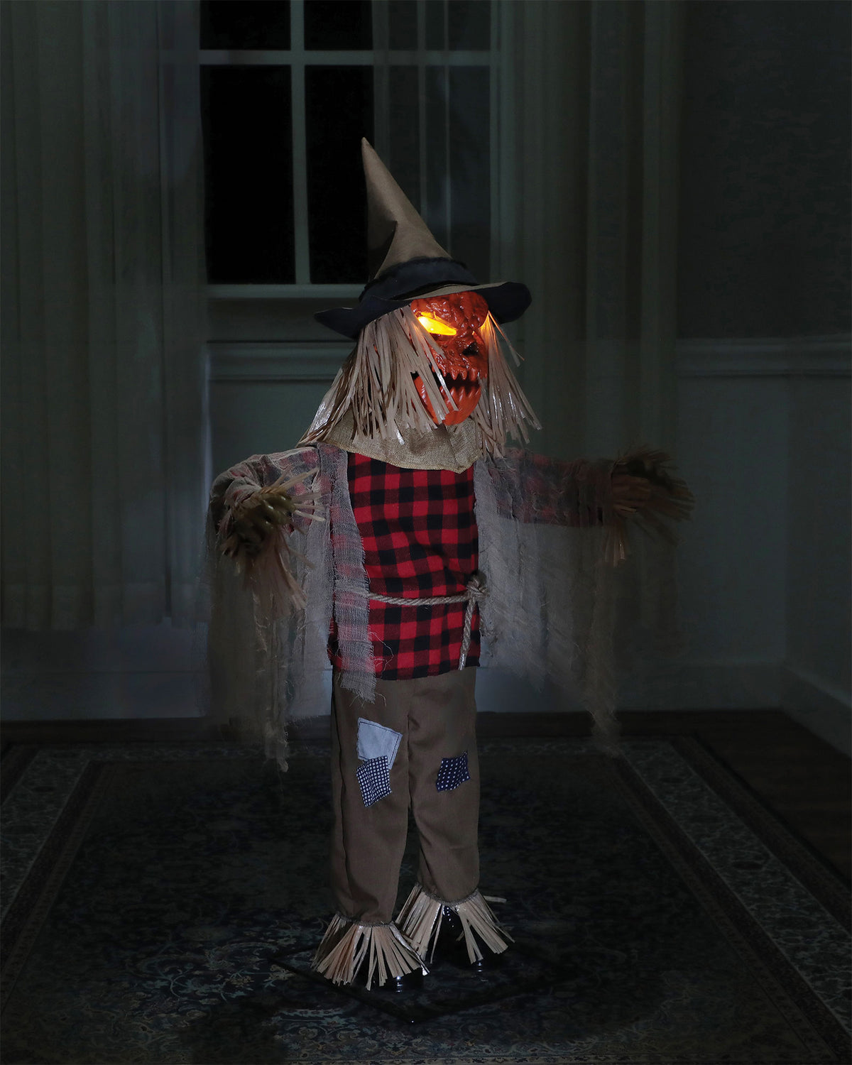 Twitching Scarecrow lit up in a dark room